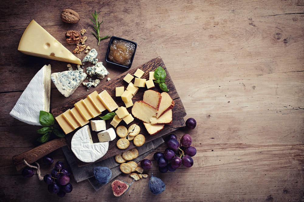 Cheese,Plate,Served,With,Grapes,,Jam,,Figs,,Crackers,And,Nuts